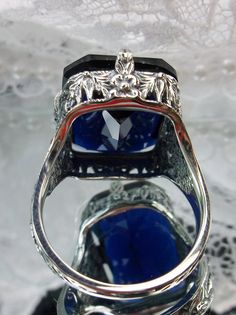 Blue sapphire Ring, Edwardian style, sterling silver filigree, with flared prong detail, Treasure design Vintage Silver Ring With Intaglio, Art Deco Silver Ring With Intaglio, Vintage Silver Intaglio Rings, Silver Art Deco Intaglio Ring, Silver Sapphire Ring With Intricate Design For Formal Occasions, Vintage Sapphire Ring As A Gift, Formal Silver Sapphire Ring With Intricate Design, Vintage Sapphire Ring For Gift, Vintage Silver Filigree Ring