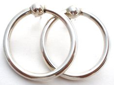 Fine Jewerly - This is a pair of sterling silver pierced round circle earrings. They are 1.25" in diameter, earrings not marked but tests for sterling, earring backs are hallmarked 925, weight is 6.2 grams. Classic Silver Circle Earrings, Classic Circle Sterling Silver Earrings, Classic Sterling Silver Circle Earrings, Silver Rounded Earrings As Gift, Silver Round Earrings As Gift, Silver Rounded Earrings For Gifting, Silver Round Earrings For Gift, Silver Open Circle Earrings For Pierced Ears, Classic Sterling Silver Round Plug Earrings