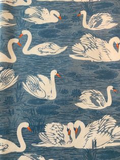 a blue and white fabric with swans on it