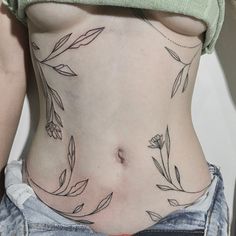 a woman's stomach with leaves on it