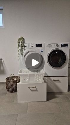 a washer and dryer sitting next to each other in a room with tile flooring