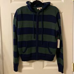 Adorable Green And Navy Striped Zip Up Sweater W Front Pockets And Hood. Size Large. 22” Pit To Pit 21.5” Length. Acrylic And Cotton. Stella Tweed. New W Tags. Casual Wool Hoodie With Drawstring, Casual Wool Hoodie For Fall, Blue Casual Cozy Outerwear, Sporty Knit Outerwear For Fall, Cozy Blue Outerwear With Ribbed Cuffs, Blue Hooded Sweater For Fall, Casual Wool Tops For Cold Weather, Casual Knit Outerwear With Drawstring Hood, Blue Fall Sweatshirt For Cold Weather