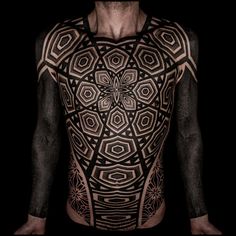 the back of a man's body with an intricate design on it