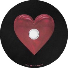 a red heart shaped object on a black disc