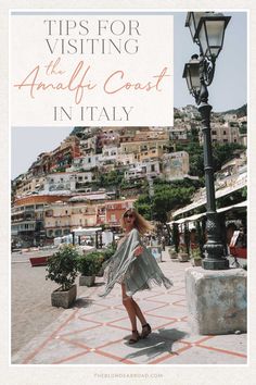 a woman standing in front of a lamp post with the words tips for visiting the amalfi coast in italy