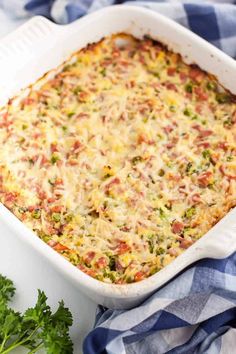 a casserole dish with broccoli, cheese and other ingredients in it