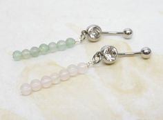 14g surgical steel belly ring with your choice of natural gemstone dangle. You choose from green aventurine or rose quartz gemstone dangle. Belly ring measures 2 3/8 inches long total length. Barbell is 14g surgical steel with a clear crystal gem. For Belly Button Rings: https://www.etsy.com/shop/AllAboutClass?section_id=18474235&ref=shopsection_leftnav_1 All body jewelry sales are final!! AllAboutClass DOES NOT accept any returns on body jewelry for sanitary reasons. This is a standard policy i Dangle Belly Rings, Button Rings, Belly Ring, Rose Quartz Gemstone, Button Jewelry, Body Piercing Jewelry, Quartz Rose, Belly Rings, Crystal Gems