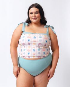 Say hello to your new favorite swim crop! Longer than a bra, shorter than a tankini, this crop has Azul ties and band at the top of our cute, custom Shell Stripe print. Built-in shelf bra for great support. Pair with matching bottoms for a set, or mix it with your favorite solid or print! Available in XXS-4XDouble lined shelf bra with foam cups82% nylon, 18% spandexFull front polyester liningProvides UV 50+ protectionResponsibly made in Mexico A portion of proceeds from this suit goes to bringin Crop Swim Top, Short One Piece, Bandeau Crop Top, Foam Cups, Swim Skirt, High Waist Bottoms, Built In Shelves, Plus Size Swimwear, Swim Dress