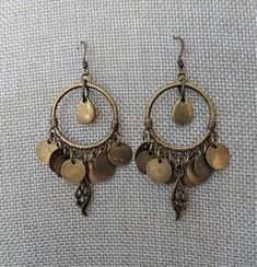 "Antique brass dangle hoops are accented with matching coin beads in these boho style earrings. The overall length of the earrings is 2 1/4\" from ear wire link. The diameter of the hoop is 1 \". all of my jewelry items come boxed, and ribbon tied and tagged for easy gifting." Antique Brass Earrings, Brass Jewellery, Boho Style Earrings, Earrings Antique, Coin Earrings, Costume Earrings, Dope Jewelry, Funky Jewelry, Antique Earrings