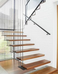 a set of wooden stairs with metal handrails