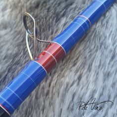 a blue and red pen laying on top of a furry surface