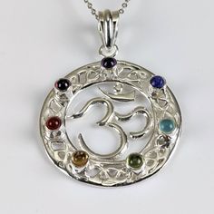 "These pendants are handcrafted from beautiful .925 sterling silver. Featuring a shiny lustrous Om symbol design with seven, high-grade, polished chakra crystals including: Root: Garnet Sacrum: Carnelian Solar Plexus: Citrine Heart: Peridot Throat: Blue topaz Third Eye: Lapis Crown: Amethyst Add a high-quality sterling silver adjustable chain. Pendant length: 1.6\" ♥️Fast & Free USA Shipping w/ purchase of $35 or more♥️ We also offer low International shipping, calculated based on your location. Om Symbol, Symbol Design, Solar Plexus, Chakra Crystals, Sterling Silver Necklace Pendants, Chain Pendant, Silver Pendant Necklace, Necklace Chain, Third Eye