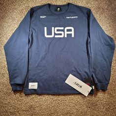 Brand New With Tags, Men's New Balance X Wtaps Tc Jersey Long Sleeve T-Shirt In Size Small. Mt01606 The Shirt Is Navy Blue And White. Measurements (+/- .25"): Top Of Neck To Bottom Hem: 26.75" Shoulder To Shoulder: 20" Pit To Pit: 20.5" Waist: 20" Bottom Hem: 21" Sleeve Length: 33" From Manufacturer's Description: New Balance And Japanese Brand Wtaps Continue Their Partnership This Season, Once Again Spotlighting The Iconic Made In The Us Range. And With This Navy Blue Tee, The References Are Im Outdoor Sportswear Tops With Letter Print, Sportswear Graphic Print Tops For Outdoor, Sportswear Tops With Graphic Print, Navy Sporty Shirt With Crew Neck, Navy Sporty Crew Neck Shirt, Sporty Tops With Logo Print For Outdoor, Sporty Navy Shirt With Crew Neck, Navy Sporty Outdoor Tops, Navy Sporty Tops For Outdoor