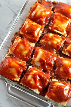 a casserole dish with meat and sauce in it on a marble counter top