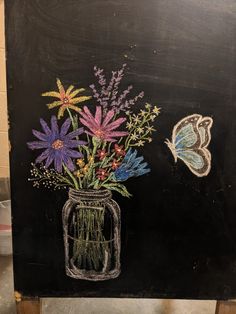 a chalkboard drawing of flowers in a mason jar with a butterfly on the side