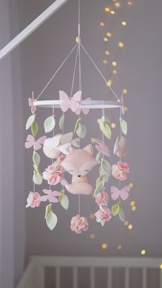 a baby crib mobile with teddy bears and flowers hanging from it's ceiling