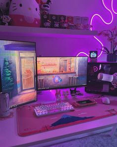 two computer monitors sitting on top of a desk in front of a keyboard and mouse