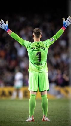 a soccer player with his hands in the air