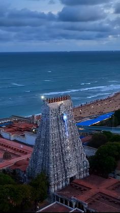 an aerial view of a very tall building next to the ocean