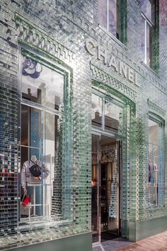 a store front with glass windows and the words chanel written on it's side