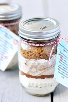 two mason jars filled with cookies on top of a table