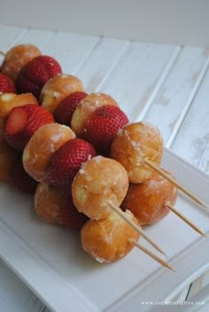 strawberries and donuts are arranged on skewers with the words breakfast written over them