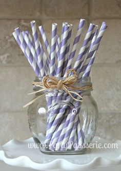 purple and white striped paper straws in a mason jar