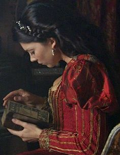 a painting of a woman reading a book