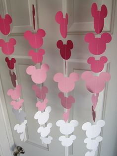 some pink and red mickey mouse decorations hanging from a door