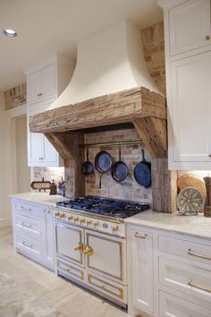 a kitchen with white cabinets and an old fashioned oven in the middle of the room