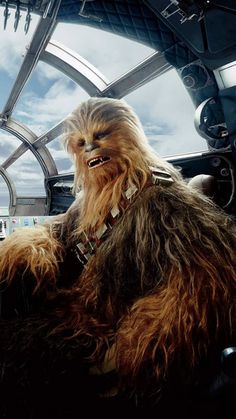 chew - oo is sitting in the cockpit of a star wars vehicle with his mouth open