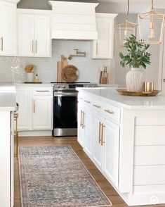 the kitchen is clean and ready for us to use it's white cabinetry