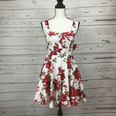 Ixia Junior’s Retro Style Fit & Flare White Dress With Red Floral Print. Tie At Waist, Zip Closure At Back. Chest Area Is Lined With Built In Bra Pads. Made In Usa. Size M Junior New With Tag. Approx. Measurements: Chest 16.5" Waist 14" Length 32" #7 Red A-line Floral Dress For Summer, Red A-line Floral Summer Dress, Fitted Red Floral Dress For Summer, White Cotton Fit And Flare Mini Dress, White Fit And Flare Mini Dress For Garden Party, Fitted Red Floral Dress For Spring, Red Fitted Floral Dress For Garden Party, Fitted White Cotton Floral Dress, Fitted Floral Print Dress For Holiday