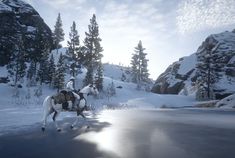 a person riding on the back of a horse across a snow covered field next to trees