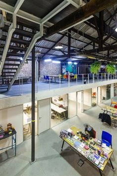 the inside of a building with tables, chairs and other things on display in it