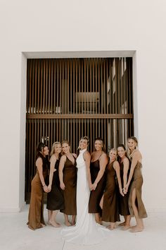 a group of women standing next to each other in front of a wall with bars