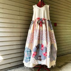 a dress hanging on a wall next to a building with a red hook in it