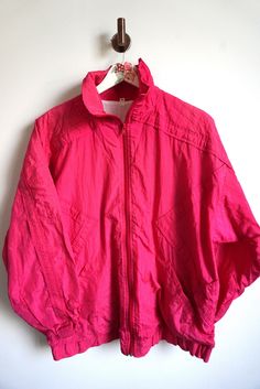 Jacket details: * Pink windbreaker  * Zipper on front * Condition: Perfect vintage condition Measurements, laying flat: Length: 26" / 66 cm Armpit to armpit: 27" / 68 cm Shoulder to shoulder: 24 1/2" / 62 cm sleeve: 29 1/2" / 50 cm Label size: M Feel free to message me with any questions Retro Pink Sports Outerwear, Pink Windbreaker, Jacket Details, Vintage Sportswear, Sport Top, Running Gear, Pink Sweatshirt, Label Sizes, Latvia