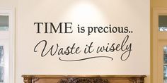 a wall that has some type of lettering on it with the words time is precious, waste it wisely