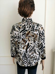 "mothers day gift womens blouse womens shirt boho blouse tiger print tiger blouse tiger shirt animal print animal shirt animal Blouse Please refer to photos for details of condition. Condition: very good vintage Measurements: Length: 65 cm/25.6 \" Sleeve : 40 cm/15.7\" Shoulder to shoulder: 47 cm/18.5\" Bust: 108 cm/42.5\" Waist 90 cm/35.4\" Size L note The color on the pictures may vary due to monitor settings and light reflections. Ready to ship Please do not hesitate to contact with me for an Leopard Print Tops For Spring, Casual Stretch Leopard Print Blouse, Black Tiger Print Long Sleeve Tops, Casual Summer Blouse With Zebra Print, Black Long Sleeve Tiger Print Tops, Black Long Sleeve Top With Tiger Print, Fitted Tiger Print Top For Fall, Casual Fitted Top With Tiger Print, Spring Leopard Print Stretch Blouse