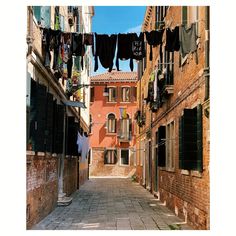 an alley way with clothes hanging out to dry