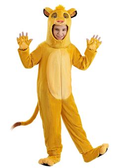 a little boy in a lion costume standing on one leg and smiling at the camera