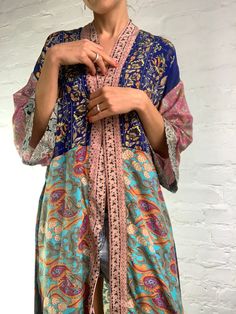 "This is gorgeous long patchwork kimono robe super comfortable made in free size with wrap tie closing lightweigh flowy daily outfit perfect on its own as well as layered over a jeans and tshirt 55\"length Thank You for looking" Bohemian Robe With Patchwork And Kimono Sleeves, Spring Robe With Patchwork And Kimono Sleeves, Bohemian Multicolor Patchwork Robe, Beach Kimono With Patchwork Sleeves, Multicolor Wrap Kimono With Patchwork, Multicolor Patchwork Wrap Kimono, Silk Kimono With Patchwork, Silk Patchwork Long Sleeve Kimono, Silk Long Sleeve Kimono With Patchwork