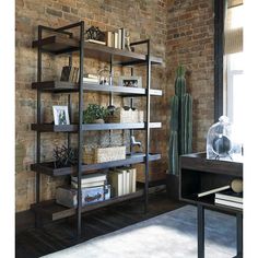 a brick wall with bookshelves and other items on the shelves in front of it