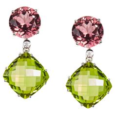 A magnificent pair of contemporary Diamond, Turmaline and Peridot drop Earrings. The earrings are mounted in 18 Karat white gold encrusted with vidid and truly stunning oval gemstones. These sensational earrings epitomize elegance and sophistication. Diamonds 0.04 Carat 2 Tourmaline 9.94Carat 2 Peridot 23.35 Carat Founded in 1974, Gianni Lazzaro is a family-owned jewelery company based out of Düsseldorf, Germany. Although rooted in Germany, Gianni Lazzaro's style and design is more reminiscent of Italian luxury and craftsmanship. The exquisite pieces and opulent gemstones embody the sunny Italian coast. Mixtures of bright gemstones and impeccable diamonds define this exuberant brand. "To Embody the beauty of a women.” Timeless, Sophisticated and Elegant. Gianni Lazzaro Italian Coast, Peridot Earrings, Dusseldorf, Italian Luxury, White Gold Diamonds, Pink And Green, Tourmaline, Gold Diamond, Jewelry Earrings Dangle