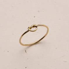 Dainty and delicate, the Love Me Knot Ring is one of the sweetest additions to our stacking kellection. Made to remember the ties to our loved ones, this beauty is the perfect gift for the special someone in your life or to permanently have your nearest and dearest close at hand. Dainty Stackable Rings As Gift, Dainty Stackable Rings Gift, Dainty Midi Rings For Gifts, Delicate 14k Gold Filled Midi Rings For Gift, Dainty Tiny Midi Rings As Gift, 14k Gold Filled Open Midi Rings As Gift, Simple 14k Gold Filled Midi Rings For Gift, Simple 14k Gold Filled Midi Rings As Gift, Delicate 14k Gold Filled Midi Rings As Gift