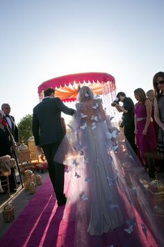 the bride and groom are walking down the aisle