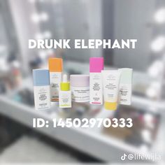 an ad for drunk elephant is displayed in front of a counter with bottles and containers on it