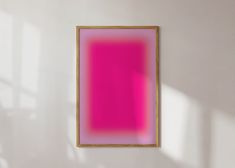 a pink and yellow painting hanging on the wall