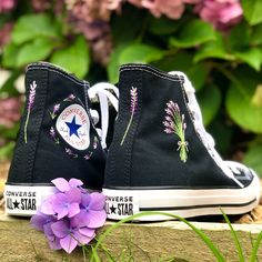 These custom Converse trainers are embroidered by hand with beautiful purple lavender flowers.  I offer the option to chose how much embroidery you would like on the shoes which all vary in price.  - The 'logo embroidery' option if for the ring of lavender that surrounds the logo on the inside of each shoe.  - The 'lavender bouquet' option is just for the bouquet of lavender which is embroidered on the outside of each shoe.  - The 'all over embroidery' option is for the logo embroidery, bouquet embroidery, and the lavender flower which is embroidered on the back of each shoe.  The embroidery is done in high quality cotton thread to create a completely unique pair of shoes.   I only purchase 100% genuine shoes from the official converse website. Sizes are in standard woman UK sizes. **Becau Spring High-top Sneakers With Embroidered Logo, Spring Embroidered High-top Sneakers, Summer Embroidered High-top Sneakers, High-top Sneakers With Embroidered Graphics For Spring, Casual Sneakers With Custom Embroidery For Spring, Summer High-top Sneakers With Floral Embroidery, High-top Floral Embroidery Sneakers For Summer, Black High-top Sneakers With Floral Embroidery, High-top Cotton Sneakers With Floral Embroidery